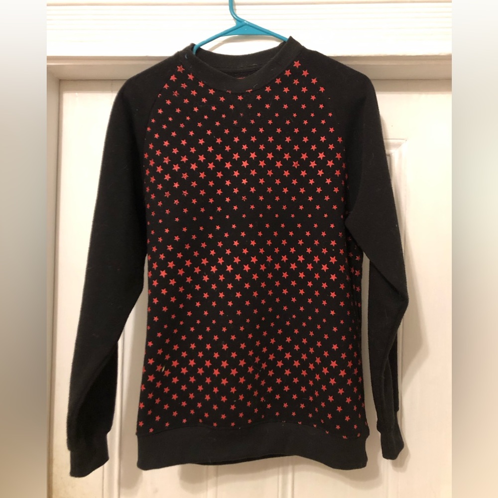 Red star pattern, black sweatshirt.